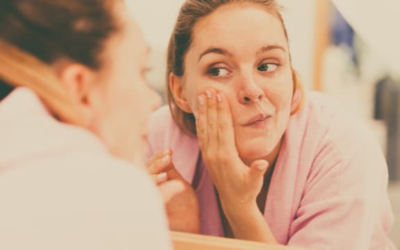 Woman cleaning her face