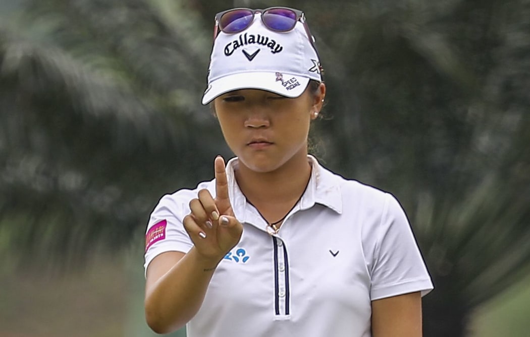 Lydia Ko lines up a putt in Malaysia, 2015.