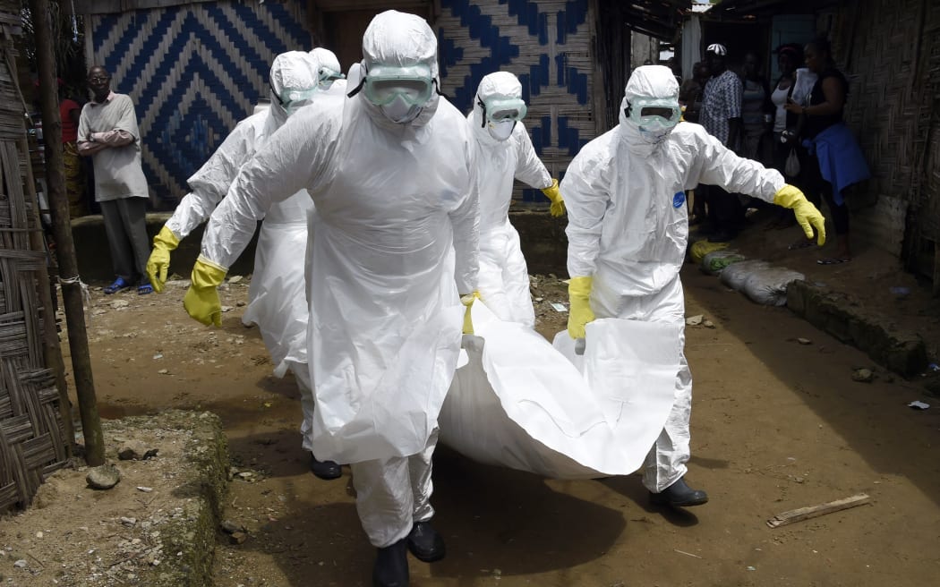 Red Cross workers carry the body of a person suspected of dying from Ebola in the Liberian capital Monrovia.