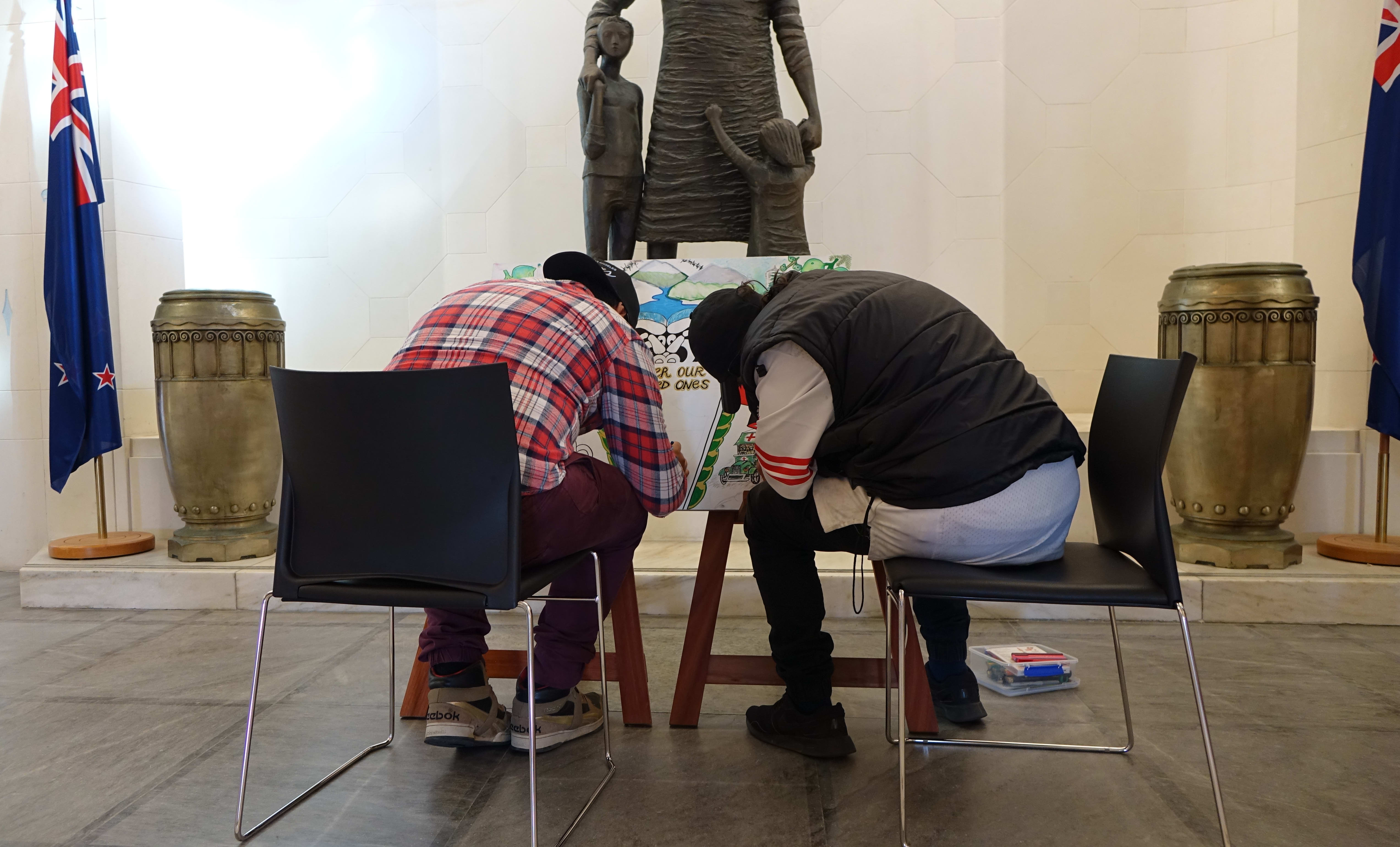 Two young offenders work on the wreath.