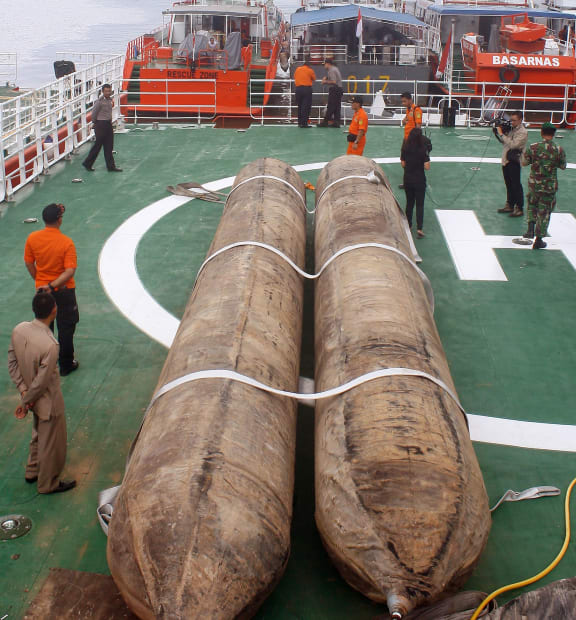 Giant lifting balloon bags are placed on the deck of the Indonesia's National Search And Rescue Agency n preparation for the recover of the fuselage of ill-fated AirAsia flight QZ8501.