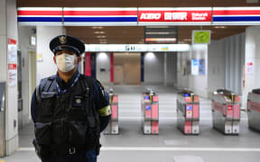 Officials are seen at the entrance of the train station Kokuryo of the Keio line where a man injured several people on the train, using fire and knife, was arrested on suspicion of attempted murder on the night of Halloween on November 1, 2021, in Tokyo, Japan.