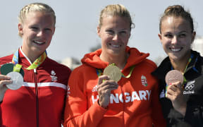 (L-R) Denmark's Emma Jorgensen, Hungary's Danuta Kozak and New Zealand's Lisa Carrington celebrate on the podium after the Women's Kayak Single (K1) 500m event at the Lagoa Stadium during the Rio 2016 Olympic Games in Rio de Janeiro on August 17, 2016.