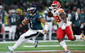 Jalen Hurts #1 of the Philadelphia Eagles is chased by Tershawn Wharton #98 of the Kansas City Chiefs in the third quarter during Super Bowl LIX at Caesars Superdome on February 09, 2025 in New Orleans, Louisiana.   Jamie Squire/Getty Images/AFP