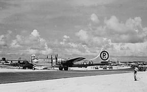 (FILES) This file photo from The National Archives taken 6 August, 1945, shows the B-29 plane "Enola Gay" after landing on Tinian Island from its mission to drop the first Atomic bomb over Hiroshima, Japan. In the middle of the Pacific ocean, an abandoned US airfield once key to dropping the nuclear bomb on Japan -- and nearly lost to history amid encroaching forest -- is being revived. But as the Americans hack away at the jungle overgrowth at Tinian island airfield and other old, World War II-era bases across the region, it won't be with Japan on their mind. Rather, it's Beijing's growing influence in the Pacific that is spurring the recovery of a slew of abandoned runways on the 40 square-mile speck of land that makes up Tinian, part of the US overseas territory of the Northern Mariana Islands. "Rehabilitation of World War II-era airfields has provided Pacific Air Forces (PACAF) a rapidly executable avenue to enhance infrastructure in the region," a spokesperson told AFP. (Photo by THE NATIONAL...