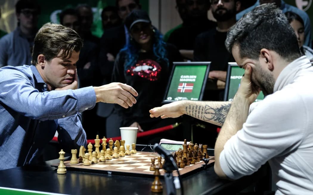 Magnus Carlsen and Ian Nepomniachtchi prepare to play in the World Blitz Chess Championship final on Tuesday.