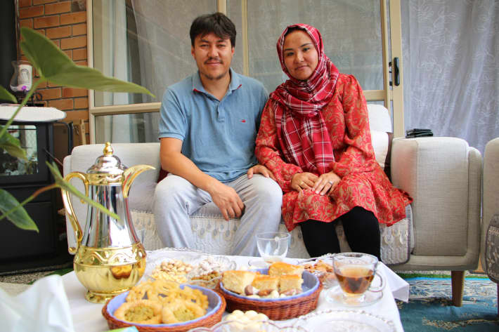 Shookria Basir and Enayatullah Basir, originally from Afghanistan's Ghazni, at their Auckland home with a spread of traditional sweets and tea.