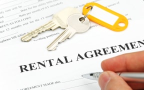 14588891 - rental agreement form with signing hand and keys and pen