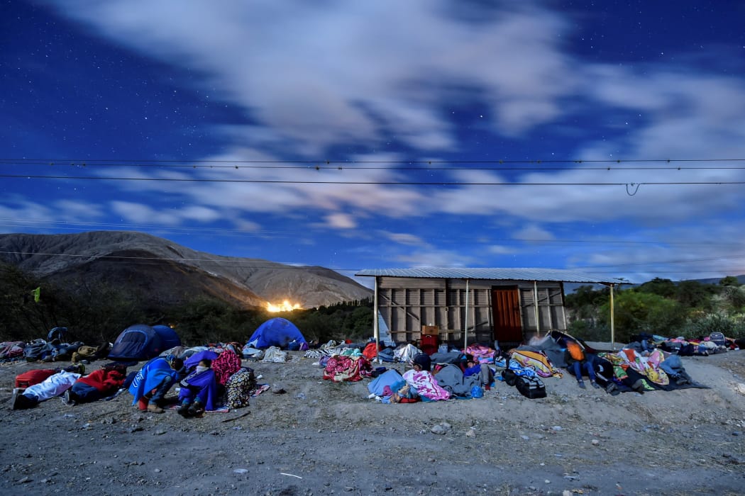 Venezuelan migrants on their way to Peru sleep along the Pan-American Highway in Ecuador, after entering the country from Colombia. 22 August 2018.