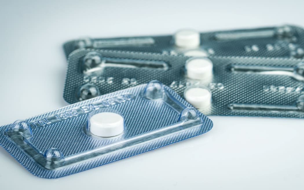Emergency contraceptive pills in blister pack on blurred background of morning after pills.