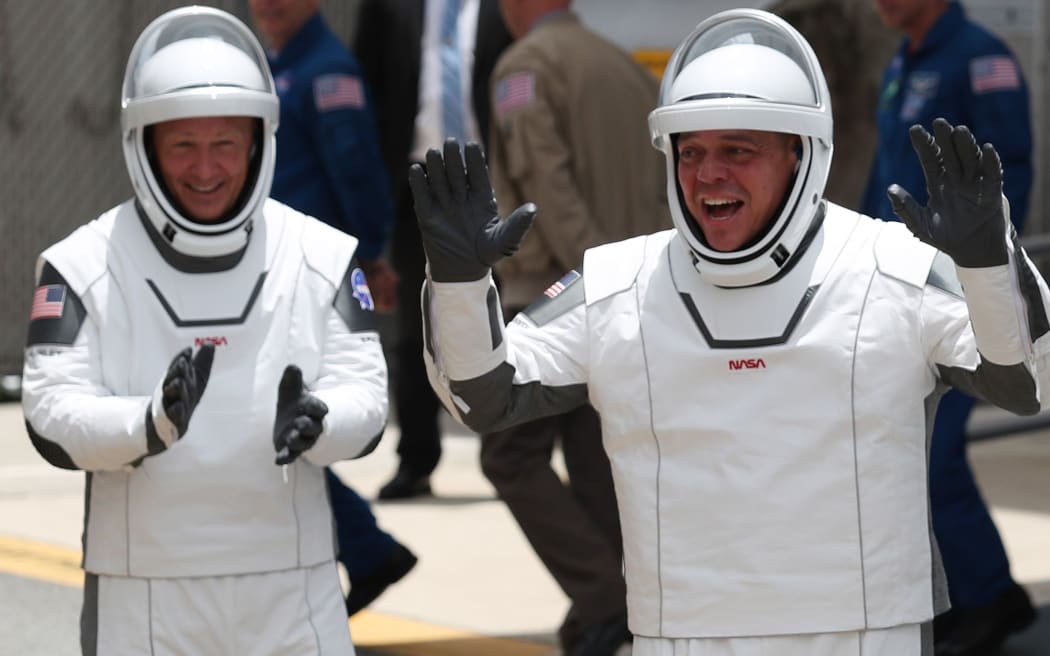 CAPE CANAVERAL, FLORIDA - MAY 27: NASA astronauts Bob Behnken (R) and Doug Hurley (L) walk out of the Operations and Checkout Building on their way to the SpaceX Falcon 9 rocket with the Crew Dragon spacecraft at the Kennedy Space Center on May 27, 2020 in Cape Canaveral, Florida.
