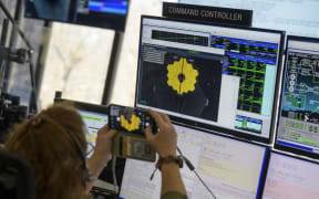 In this photo released by NASA, engineering teams at NASAs James Webb Space Telescope Mission Operations Center at the Space Telescope Science Institute in Baltimore, Maryland, monitor progress as the observatorys second primary mirror wing rotates into position, on January 8, 2022.