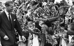 The Duke of Edinburgh Prince Philip is greeted by cheering children at Waipukurau, during the first Royal visit to New Zealand in 1953.