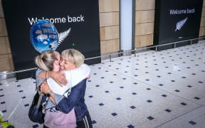A passenger hugs a family member on arrival from New Zealand at Sydney International Airport on October 16, 2020, after Australias border rules were relaxed under a new one-way trans-Tasman travel agreement that allow travellers from New Zealand to visit NSW without having to quarantine.