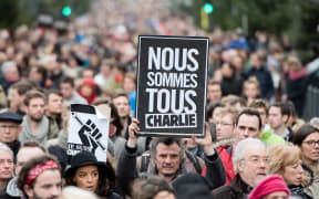 A man holds a sign reading "We are all Charlie" at a rally in the city of Lille, northern France.