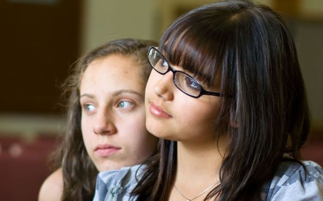 Two girls listening