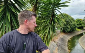 North Shore councillor Richard Hills at Wairau Creek, which filled with torrential rain in the 2023 floods.