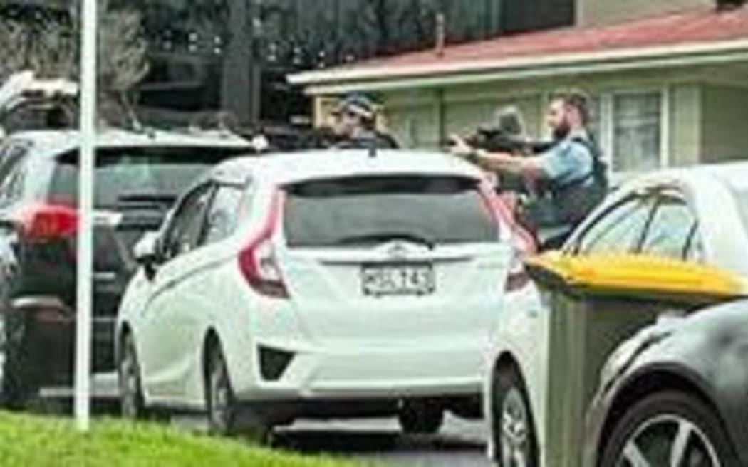 Police surround a property in the west Auckland suburb of New Lynn 17 July 2024
