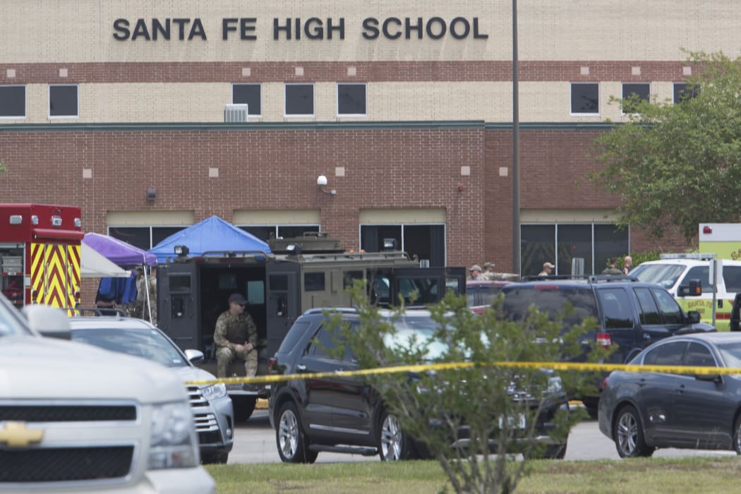 Emergency crews gather in the parking lot of Santa Fe High School where at least 8 people were killed on 18 May, 2018.