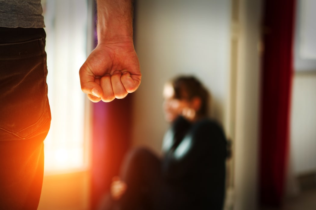 Man beating up his wife illustrating domestic violence