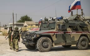 Russian soldiers reposition in the town of Derouna Arha near the Syrian border with Turkey on June 16, 2020.