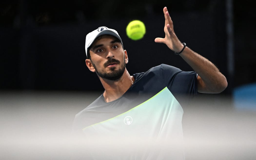 Lebanon's Hady Habib eyes the ball as he hits a shot against China's Bu Yunchaokete during their men's singles match on day one of the Australian Open tennis tournament in Melbourne on January 12, 2025. (Photo by Paul Crock / AFP) / -- IMAGE RESTRICTED TO EDITORIAL USE - STRICTLY NO COMMERCIAL USE --