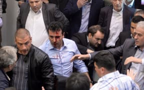Opposition Social Democrats leader Zoran Zaev bleeds after being injured in the brawl.