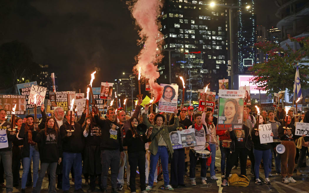 Supporters and relatives of Israeli hostages held captive in the Gaza Strip since the October 7, 2023 attacks by Palestinian militants, demonstrate in Tel Aviv on January 19, 2025, calling for an immediate end of the war and return of all the hostages. The first three Israeli hostages were released on January 19 under a long-awaited Gaza truce aimed at ending more than 15 months of war that has ravaged the Palestinian territory. (Photo by Menahem Kahana / AFP)