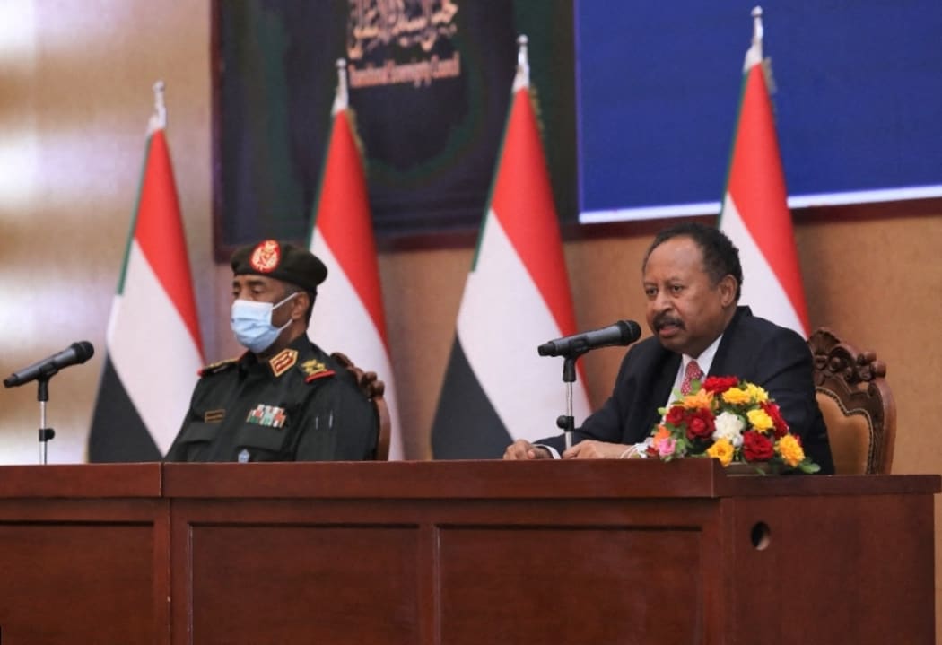 General Abdel Fattah al-Burhan, left, and Sudanese Prime Minister Abdalla Hamdok appeared on TV to sign a power-sharing agreement.
