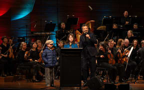 Bret McKenzie, host of the Creepy-Crawly Carnival, with two young members of the audience at the first show in Wellington