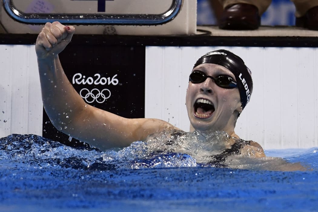 US swimmer Katie Ledecky celebrates breaking her own world record for the women's 400m freestyle at the Rio 2016 Olympic Games on 8 August 2016 (NZT).