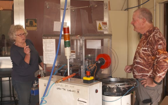 Carolyn Livingstone and Brian Frances (Skin) at the poppy making machine.