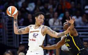 Brittney Griner of the Phoenix Mercury controls the ball against Joyner Holmes of the Los Angeles Sparks in their WNBA game in Los Angeles.