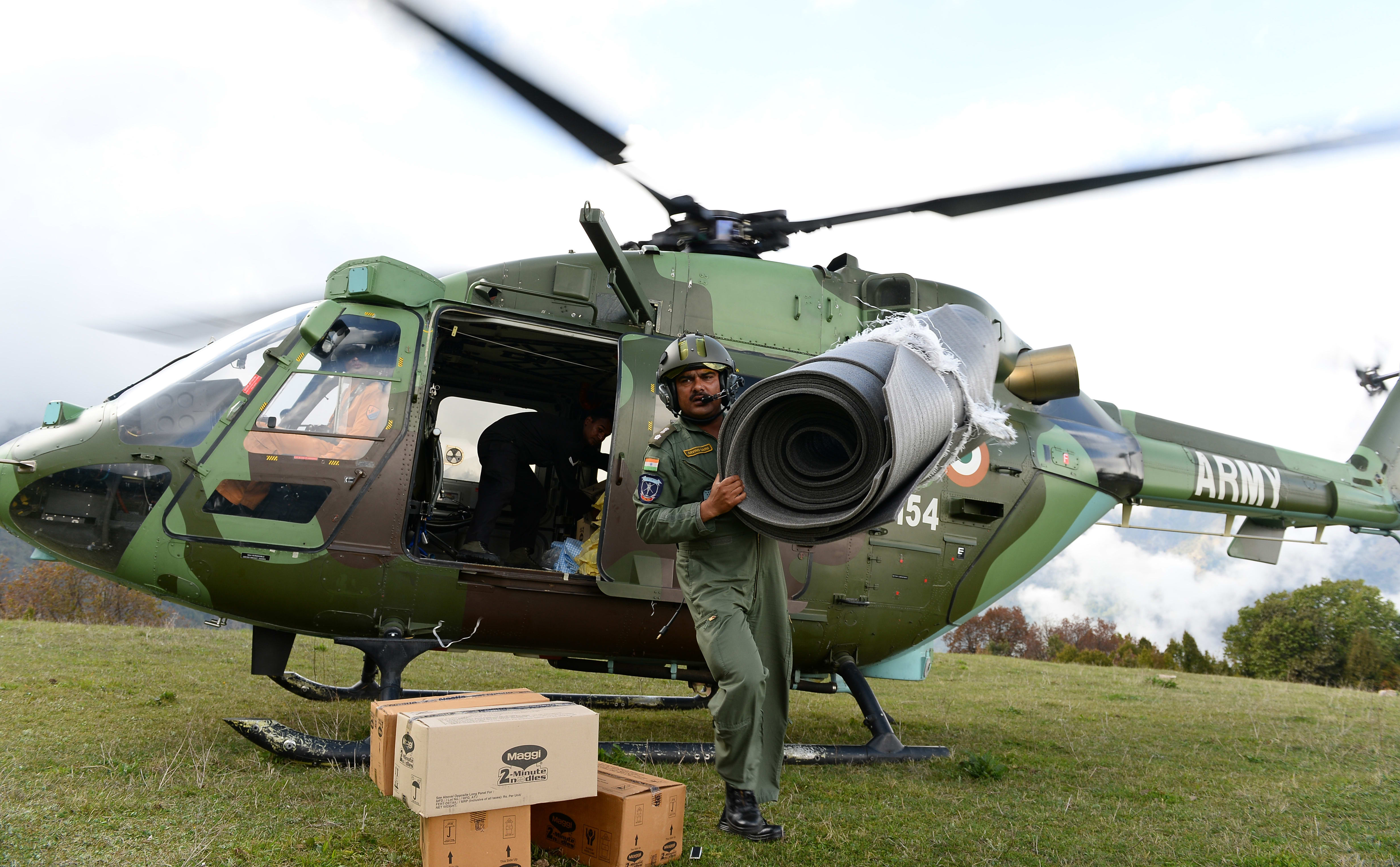 An Indian Air Force (IAF) helicopter pilot unloads relief aid in the village of Laprak.