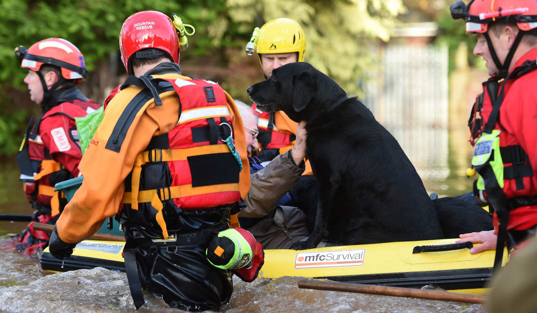 Members of the emergency services rescue residents and thier dogs in Carlisle on December 6, 2015.