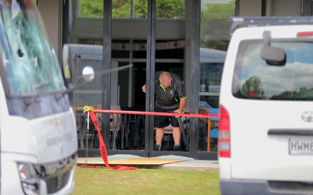 A worker repairs a broken door window at Massey High School, west Auckland on 29 November 2024.