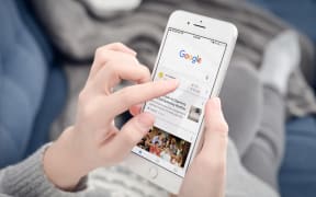 Kyiv, Ukraine - January 24, 2018: Woman using Google app on  Apple iPhone 8 plus at home. Google it is the most-used search engine on the World Wide Web,