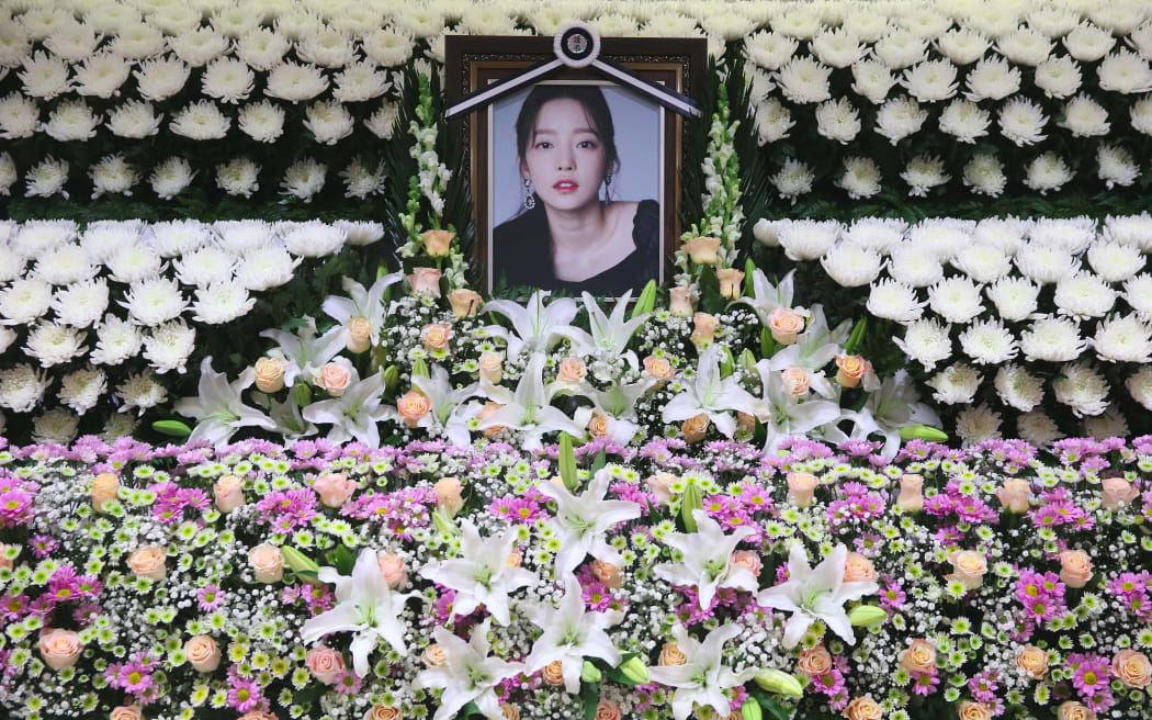 The portrait of late K-pop star Goo Hara is seen surrounded by flowers at a memorial altar at a hospital in Seoul on November 25, 2019.
