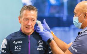Melbourne Storm coach Craig Bellamy has his temperature checked.