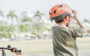 Little boy riding a bike in the park. Child on bicycle. Looking forward ahead.
