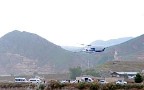 In this photo provided by Islamic Republic News Agency, IRNA, the helicopter carrying Iranian President Ebrahim Raisi takes off at the Iranian border with Azerbaijan after President Raisi and his Azeri counterpart Ilham Aliyev inaugurated dam of Qiz Qalasi, or Castel of Girl in Azeri, Iran, Sunday, May 19, 2024. A helicopter carrying President Raisi suffered a "hard landing" on Sunday, Iranian state media reported, without elaborating. (Ali Hamed Haghdoust/IRNA via AP)
