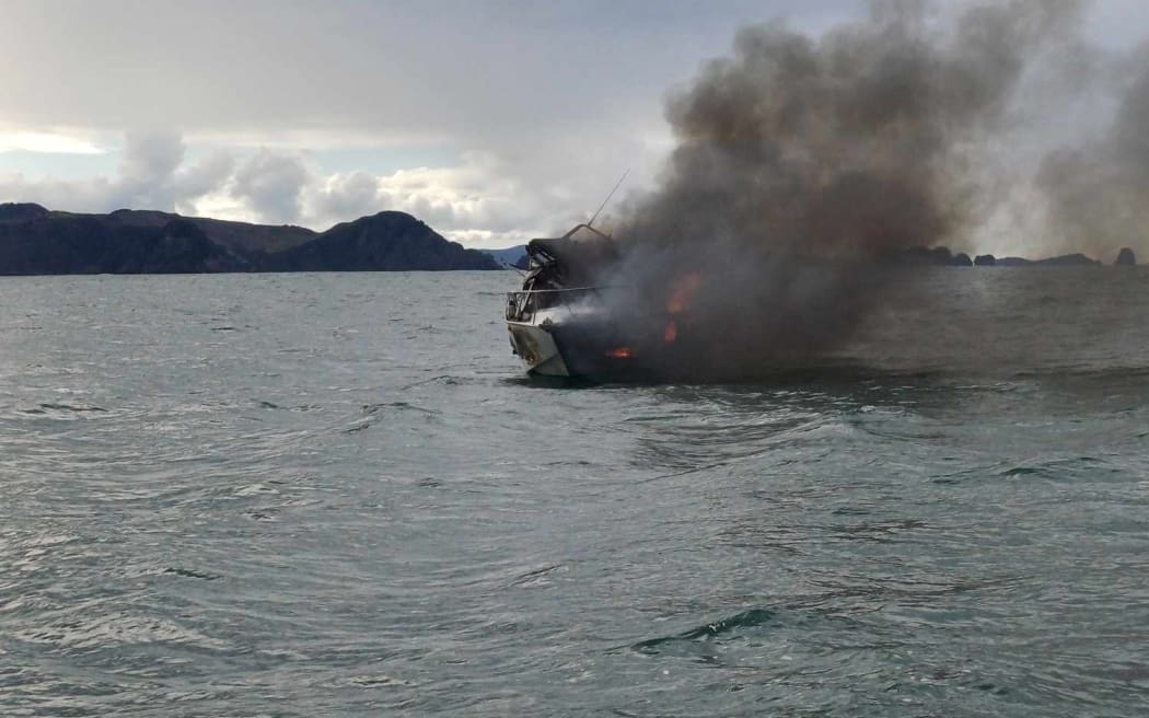 The damaged boat has holes in the side of the hull but remains afloat.