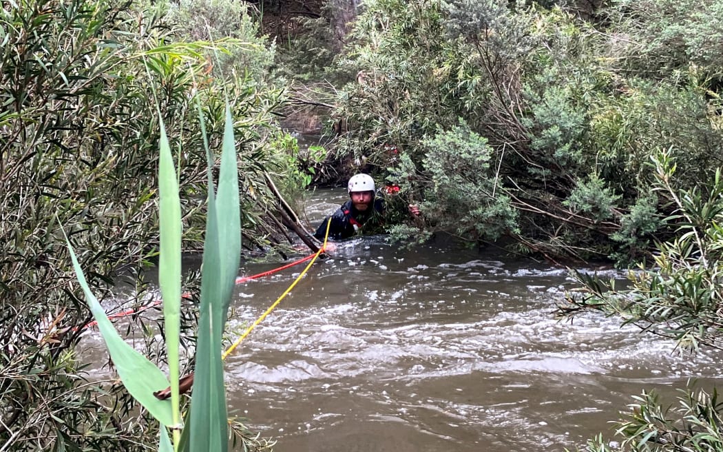 This handout photo taken and released by the Victoria Police on 27 December, 2023 shows an emergency worker during a rescue operation in the midst of flood waters after heavy rain at the Buchan campground in east Gippsland, east of Melbourne in the Australian state of Victoria. Rescue crews were searching for survivors after seven people died in heavy storms across Australia's eastern seaboard, including a 40-year-old woman sucked into a stormwater drain.