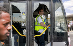 A member of Israel's ZAKA search and rescue emergency services stands inside a damaged bus at the scene of a shooting at the Ramot road junction in Israeli-annexed east Jerusalem on 8 September, 2025.