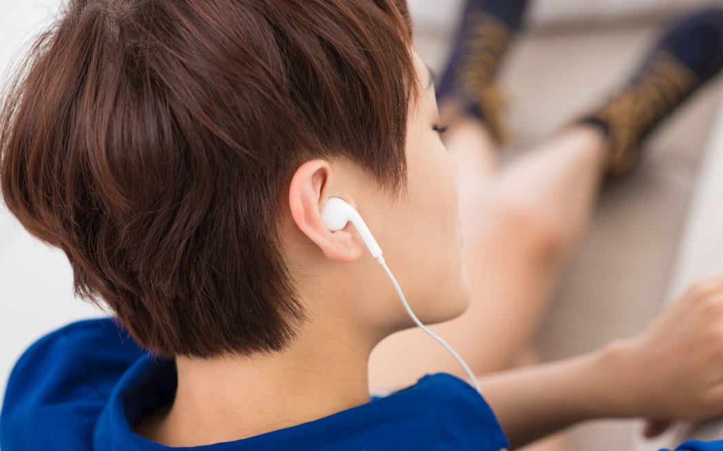 Close-up of a female ear with headphone