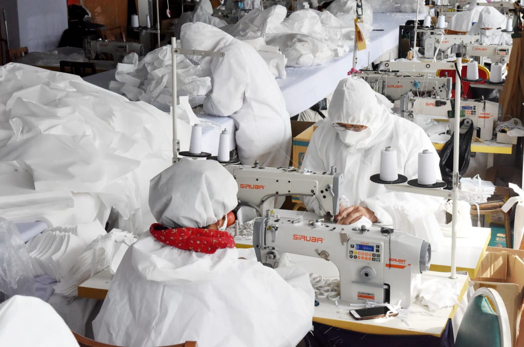 Workers make face masks at the workshop of Maliya Garments in Qingdao, east China's Shandong Province.
