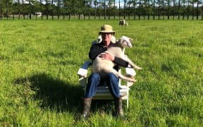 Journalist Greg Dixon with one of his lambs