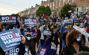 Supporters listen as Democratic presidential candidate Joe Biden speaks in Philadelphia, Pennsylvania, on November 3, 2020.