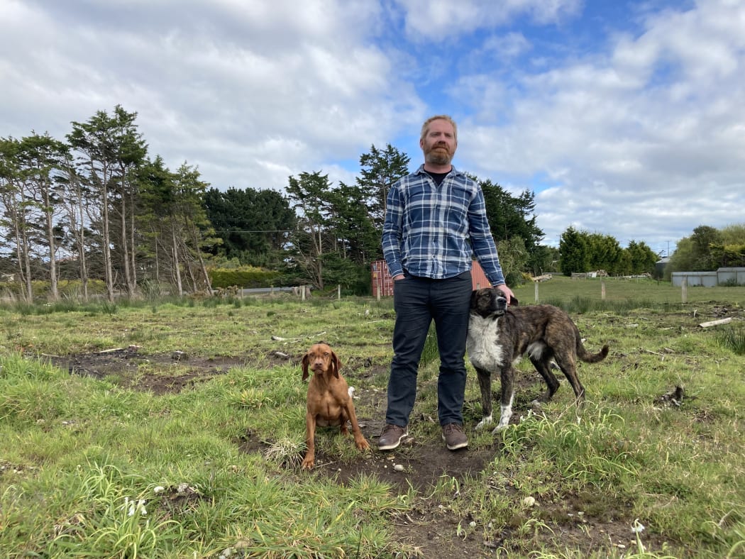 Nathan Hogg says the waiting game he's playing with the council has pushed him to breaking point. He is pictured on the one acre of land he's trying to subdivide in Colac Bay