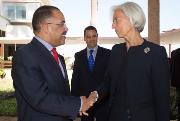 This handout photo released by the International Monetary Fund (IMF) shows IMF Managing Director Christine Lagarde (R) greeted by Mozambique's Finance Minister Manuel Chang on May 28, 2014 at the Maputo International Airport in Maputo. AFP)
